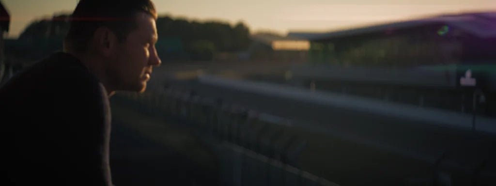 A runner moving outdoors at sunset.