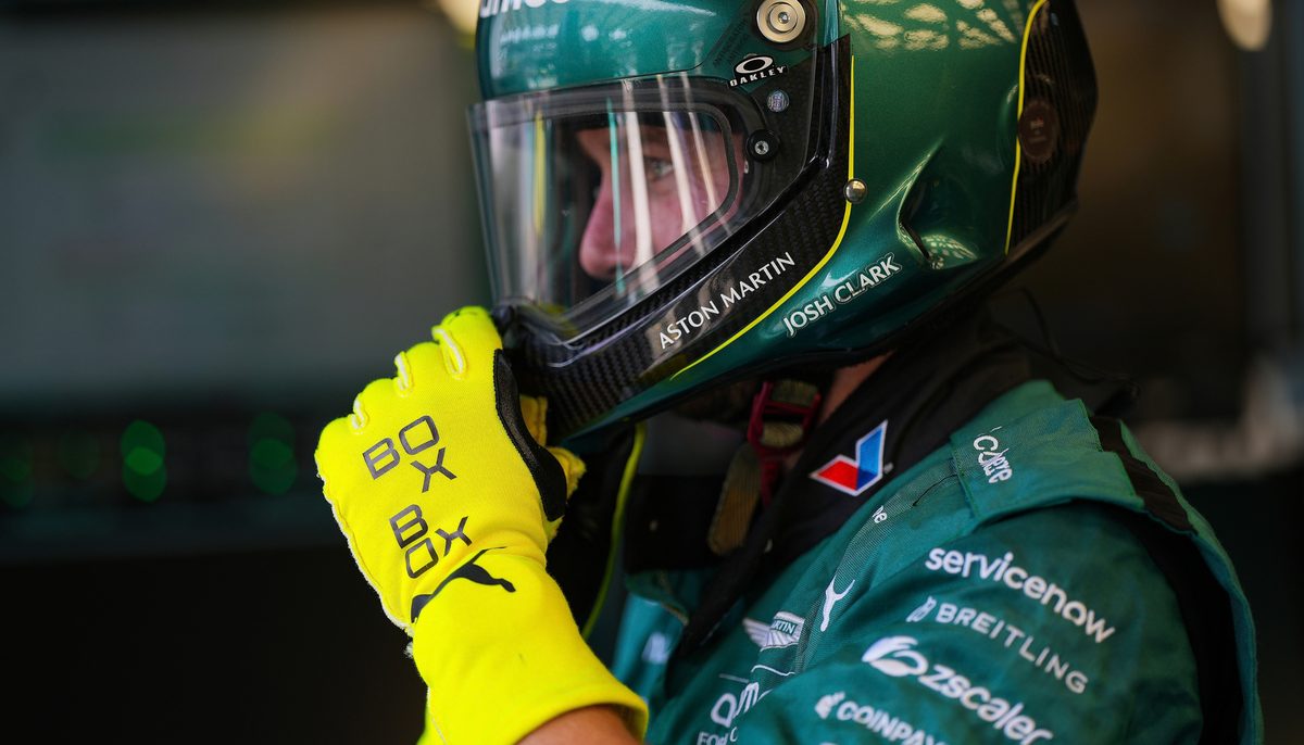 Crew of Aston Martin Aramco Formula One team prepares for pit stop in BOXBOX gloves. 