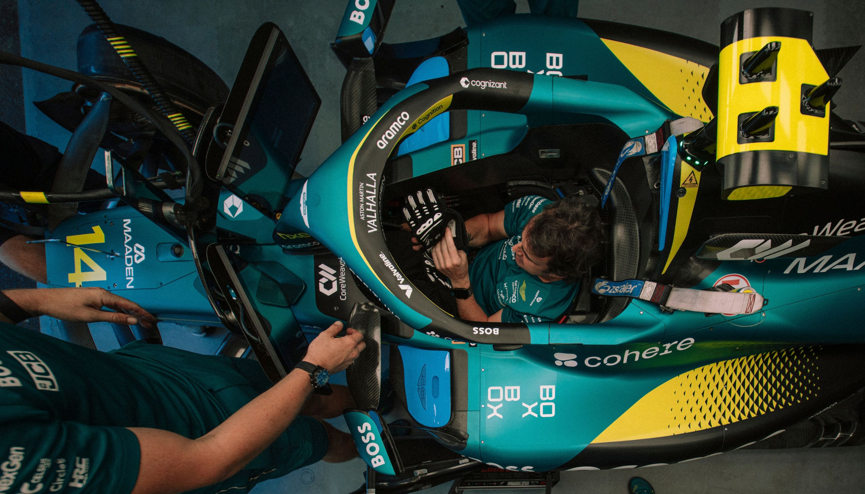 Overhead view of an Aston Martin Formula One cockpit, with BOXBOX branding on the car.